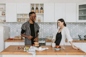 Candid conversation in a stylish kitchen, highlighting modern lifestyle.